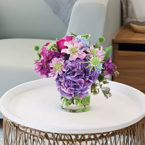 Mixed hydrangea flower arrangement in side table